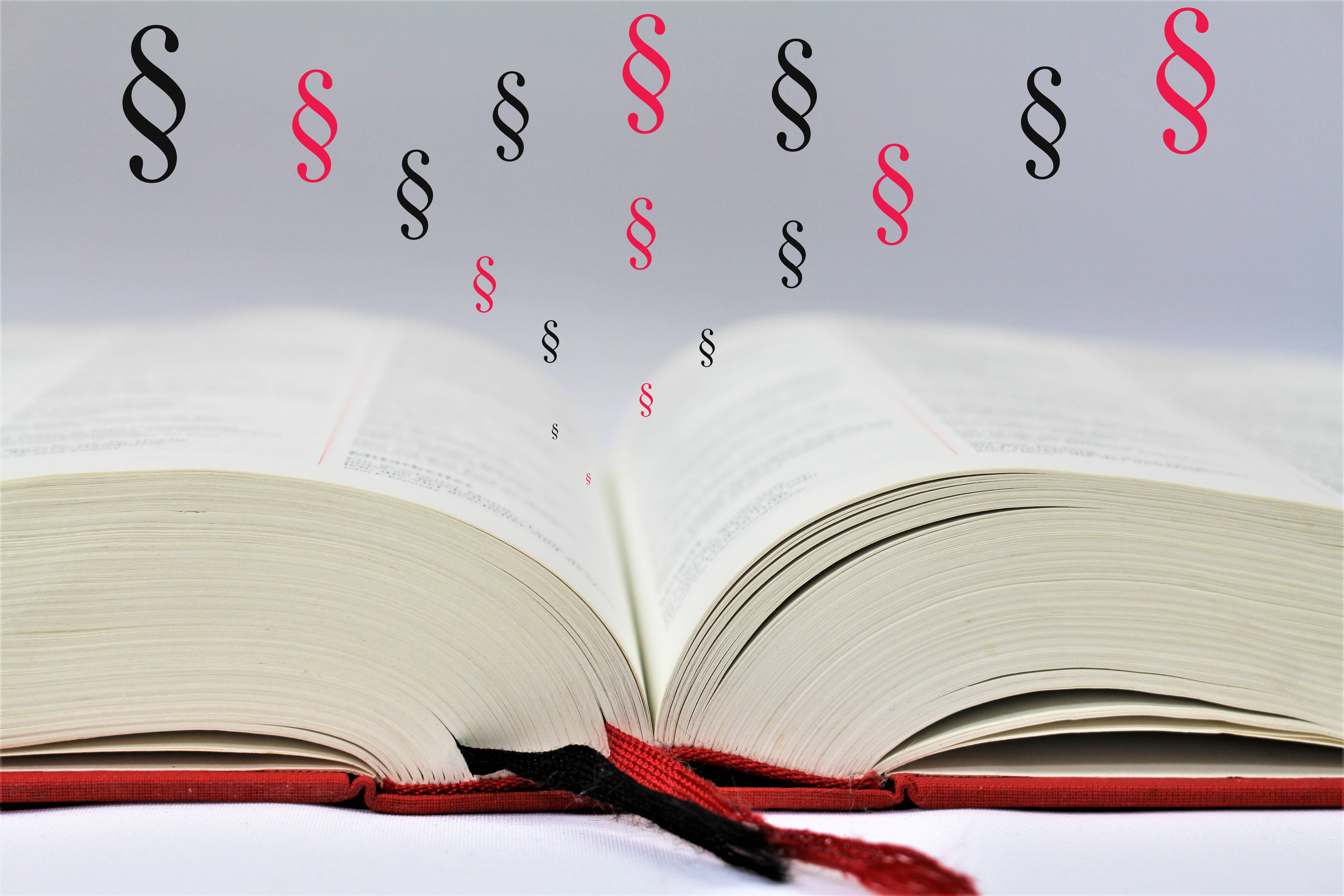 En åben bog med paragraftegn 